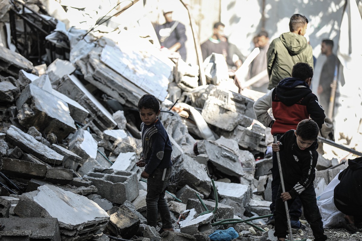 فلسطينيون يتفقدون منزلاً (تضرر سابقاً جراء غارة جوية إسرائيلية) انهار على سكانه، ما أسفر عن وفاة رجل ونجله الصغير في مخيم المغازي للاجئين وسط قطاع غزة، 5 يناير/كانون الثاني 2026. صورة: رمزي أبو عامر