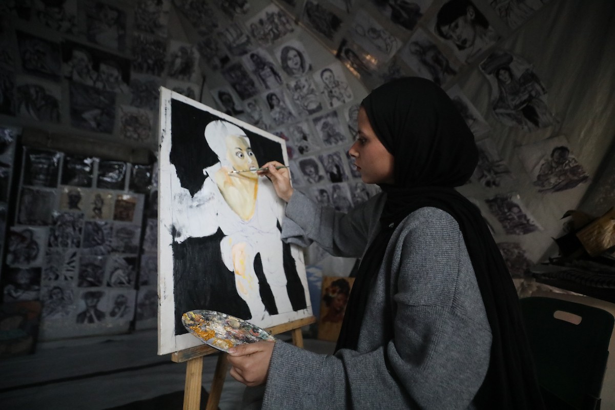 الفلسطينية مرَح خالد الزعانين (18 عاما) تحول خيمة نزوحها في مدينة غزة إلى معرض فني، 28 يناير/كانون الثاني 2026. تصوير: عمر أشتوي