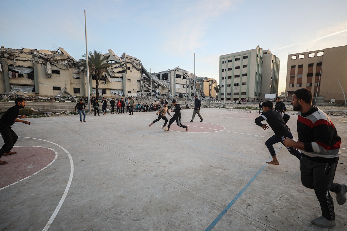   شبان فلسطينيون نازحون يلعبون كرة القدم في ملعب مدمر بمدينة غزة، في 10 يناير/كانون الثاني 2026. صورة: عمر أشتوي