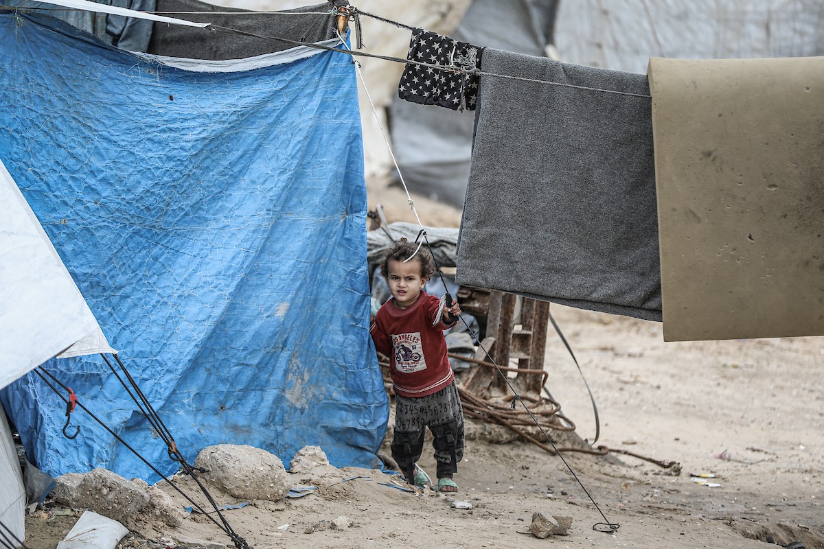 يتفقد فلسطينيون نازحون خيامهم بعد أن تضررت بشدة جراء عاصفة هوائية قوية ضربت مخيمًا للنازحين وسط قطاع غزة. 22 يناير/كانون الثاني 2026. تصوير: رمزي أبو عامر