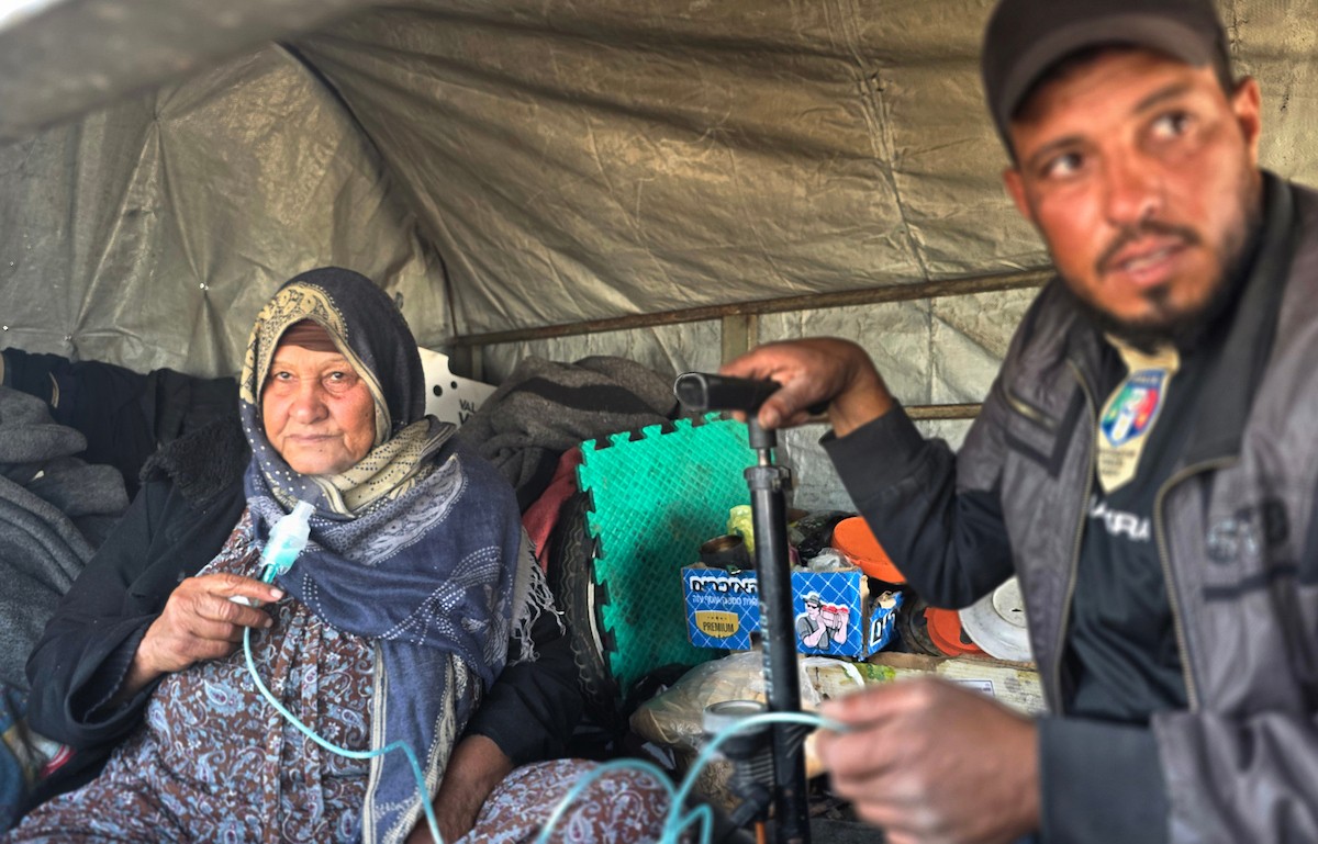 يعيش الفلسطيني سامي أبو سعادة مع والدته داخل عربة جرار، ويستخدم مضخة نفخ مطاطية لمساعدة والدته التي تعاني من صعوبة في التنفس. خان يونس، جنوب قطاع غزة، 7 يناير/كانون الثاني 2026، صورة: طارق محمد