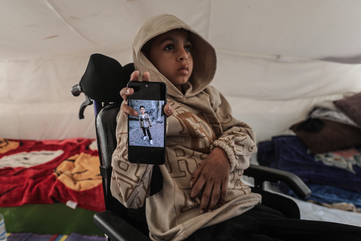 الطفل سيف رامي حجازي (13 عاما) أُصيب بشلل كامل وفشل كلوي إثر قصف إسرائيلي لخيمة عائلته، وتتولى والدته رعايته في ظروف إنسانية بالغة الصعوبة بمخيم المغازي، وسط قطاع غزة، 30 يناير/كانون الثاني 2026. صورة: معز صالحي