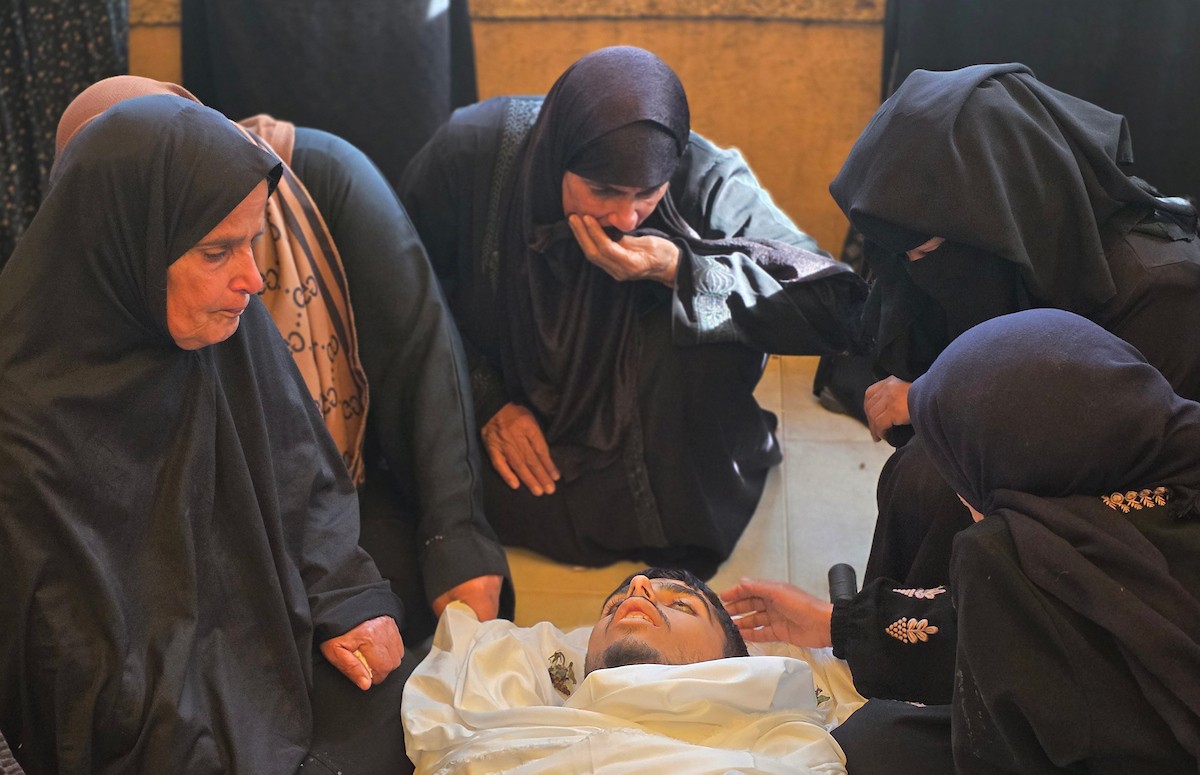 فلسطينيون يودعون جثمان الشاب محمد أسامة عمران، البالغ من العمر 19 عامًا، في مجمع ناصر الطبي بخان يونس، بعد أن استشهد برصاص القوات الإسرائيلية في وسط خان يونس، جنوب قطاع غزة. 29 يناير/كانون الثاني 2026. تصوير: طارق محمد (APA Images)