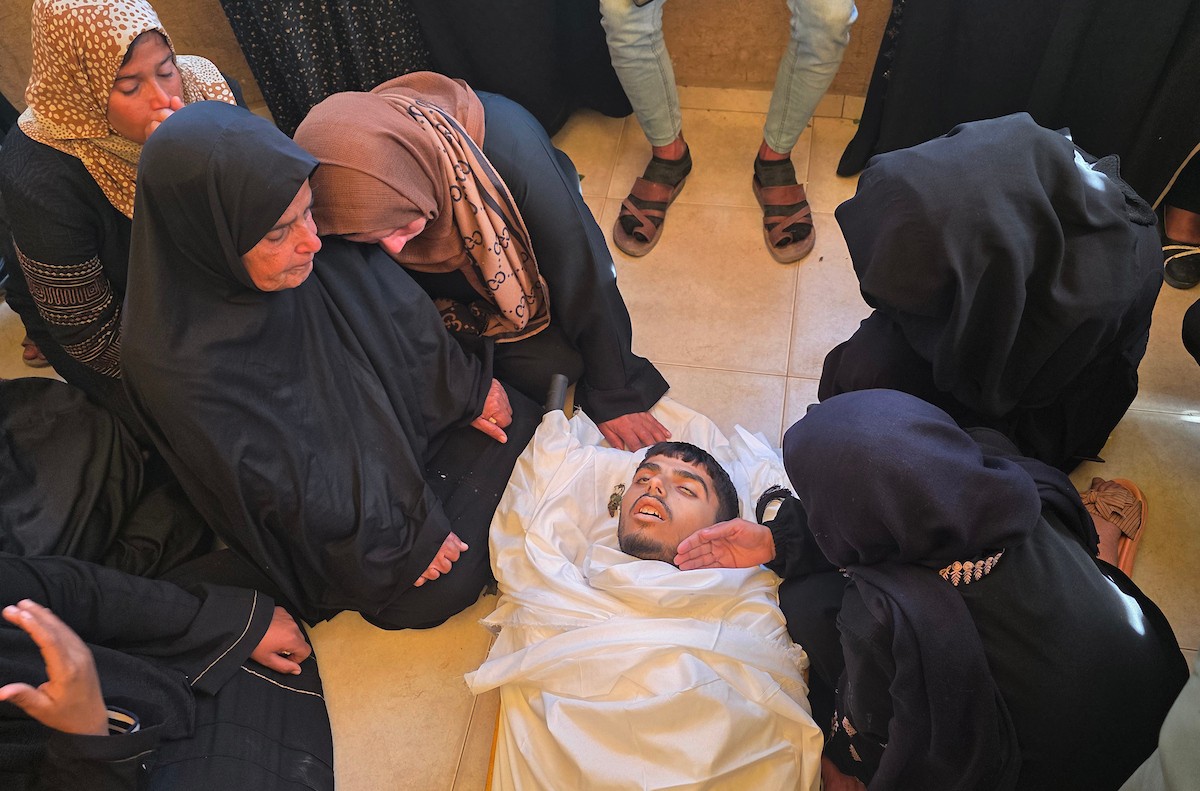 فلسطينيون يودعون جثمان الشاب محمد أسامة عمران، البالغ من العمر 19 عامًا، في مجمع ناصر الطبي بخان يونس، بعد أن استشهد برصاص القوات الإسرائيلية في وسط خان يونس، جنوب قطاع غزة. 29 يناير/كانون الثاني 2026. تصوير: طارق محمد (APA Images)