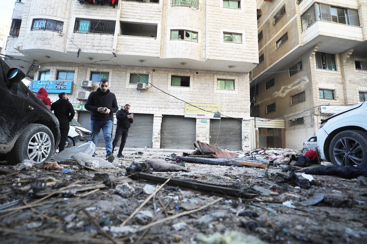 فلسطينيون يمرون أمام مبنى سكني تضرر جراء غارة عسكرية إسرائيلية أسفرت عن سقوط عدد من الضحايا في مدينة غزة، السبت 31 يناير/كانون الثاني 2026. صورة: عمر أشتوي