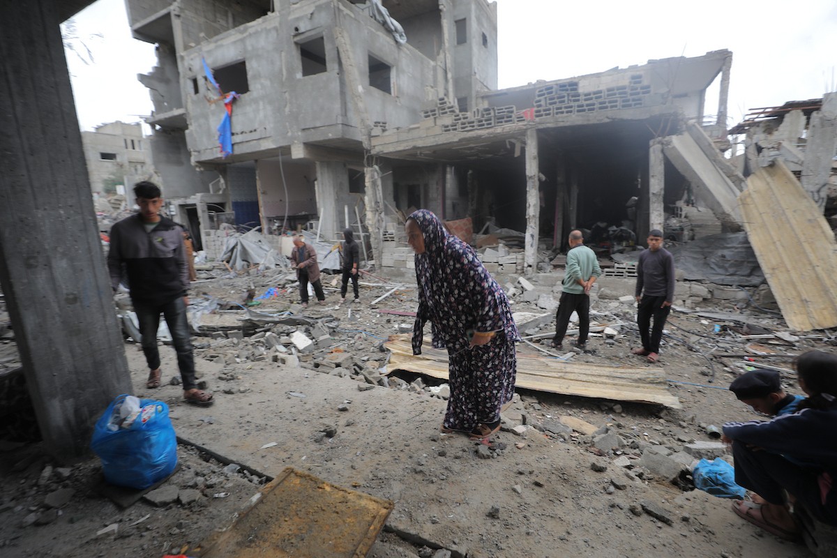 يبحث فلسطينيون عن ممتلكاتهم بين الأنقاض بعد أن دمرت غارات جوية إسرائيلية مبنى في مخيم البريج للاجئين وسط قطاع غزة. دمر الهجوم المبنى بالكامل وألحق أضرارًا بالمنشآت المحيطة به، 9 يناير/كانون الثاني 2026. صورة: معز صالحي