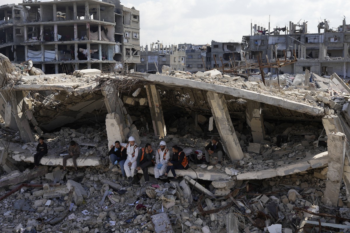 تحاول فرق الدفاع المدني الفلسطيني، بالتنسيق مع اللجنة الدولية للصليب الأحمر، انتشال جثث عائلتي عيادة وغنيم من تحت أنقاض منزل عائلة غباين، في بيت لاهيا، شمال قطاع غزة. 22 فبراير/شباط 2026. صورة: عمر أشتوي