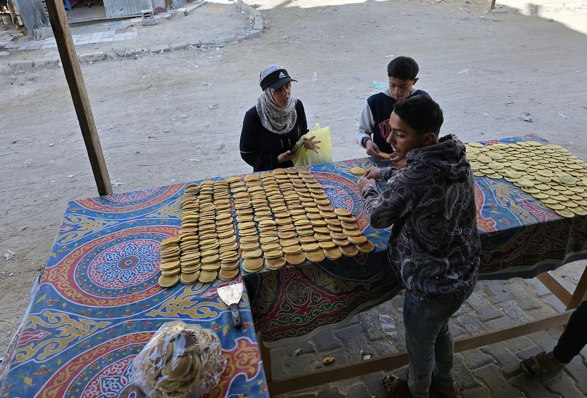 سليم البيوك ُيعدّ معجنات القطايف التقليدية باستخدام أساليب بدائية تعتمد على الحطب والنارمُواصلاً إحياء تقاليد شهر رمضان منذ أكثر من 20 عاماً، في سوق كراج رفح في خان يونس، جنوب قطاع غزة، في 12 فبراير/شباط 2026.تصوير: طارق محمد