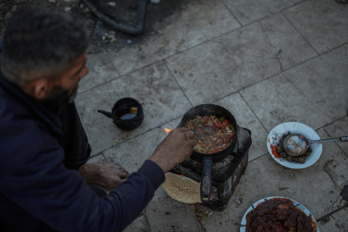 عائلة فلسطينية نازحة من بيت حانون تفطر في ثاني أيام رمضان في خيمة متداعية وسط أنقاض مسجد الحساينة على شاطئ مدينة غزة.19 فبراير/شباط 2026. تصوير: عمر أشتوي