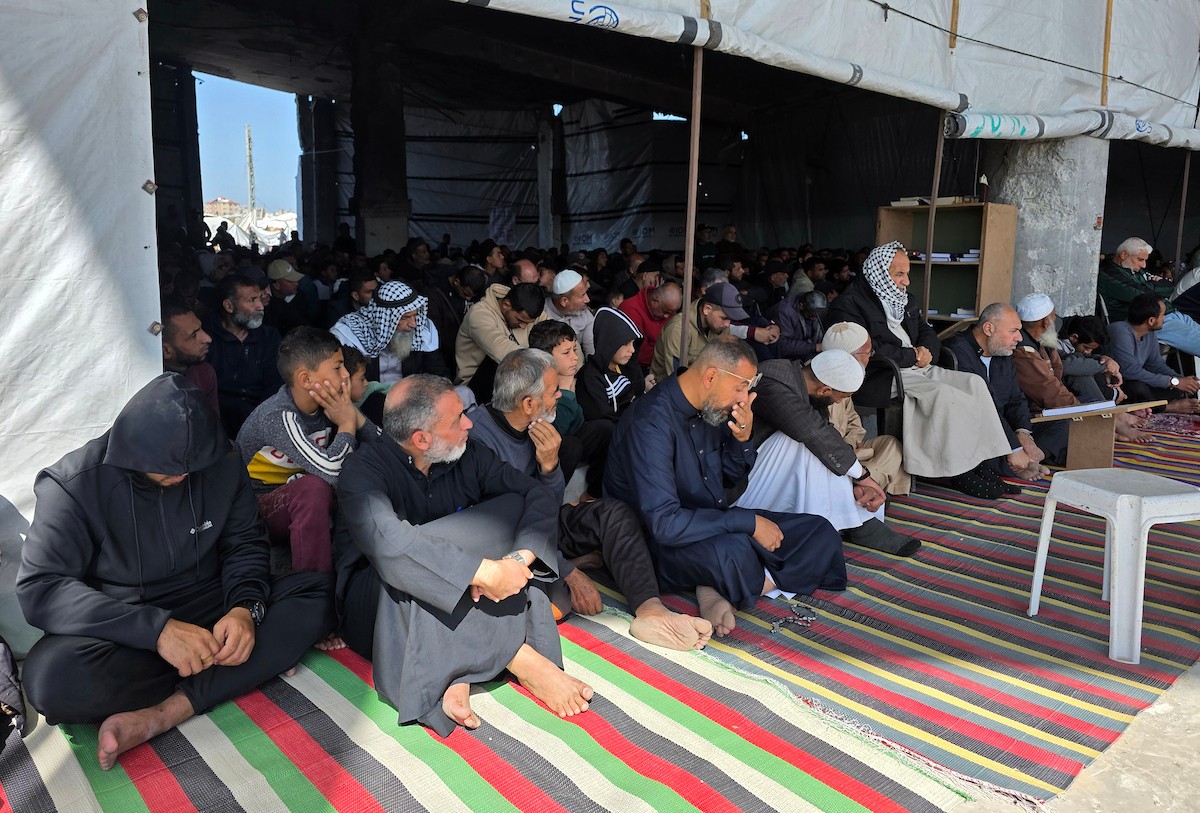 يؤدي الفلسطينيون أول صلاة جمعة من شهر رمضان المبارك وسط أنقاض مسجد الألباني في خان يونس، غزة، في 20 فبراير/شباط 2026. صورة: طارق محمد