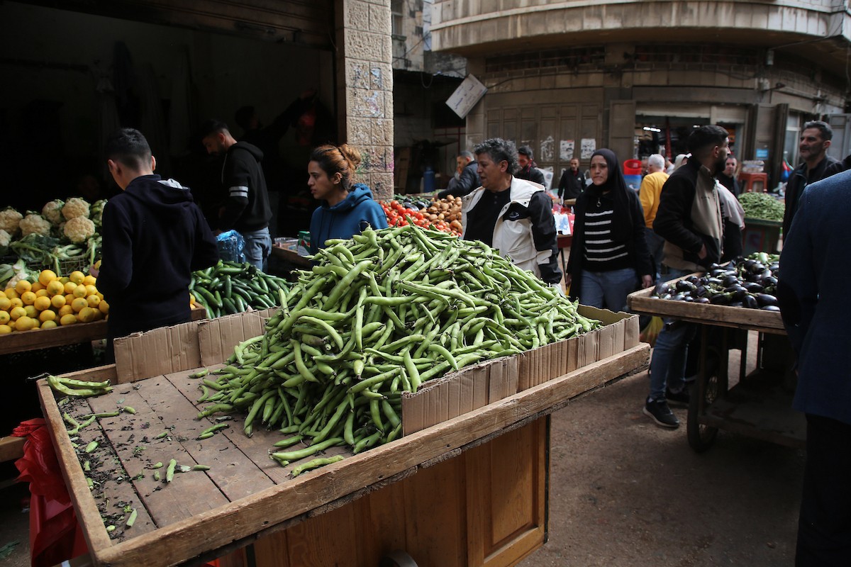 فلسطينيون يتسوقون استعدادًا للإفطار في أول أيام شهر رمضان المبارك، في مدينة نابلس بالضفة الغربية، 18 فبراير/شباط 2026. صورة: محمد ناصر