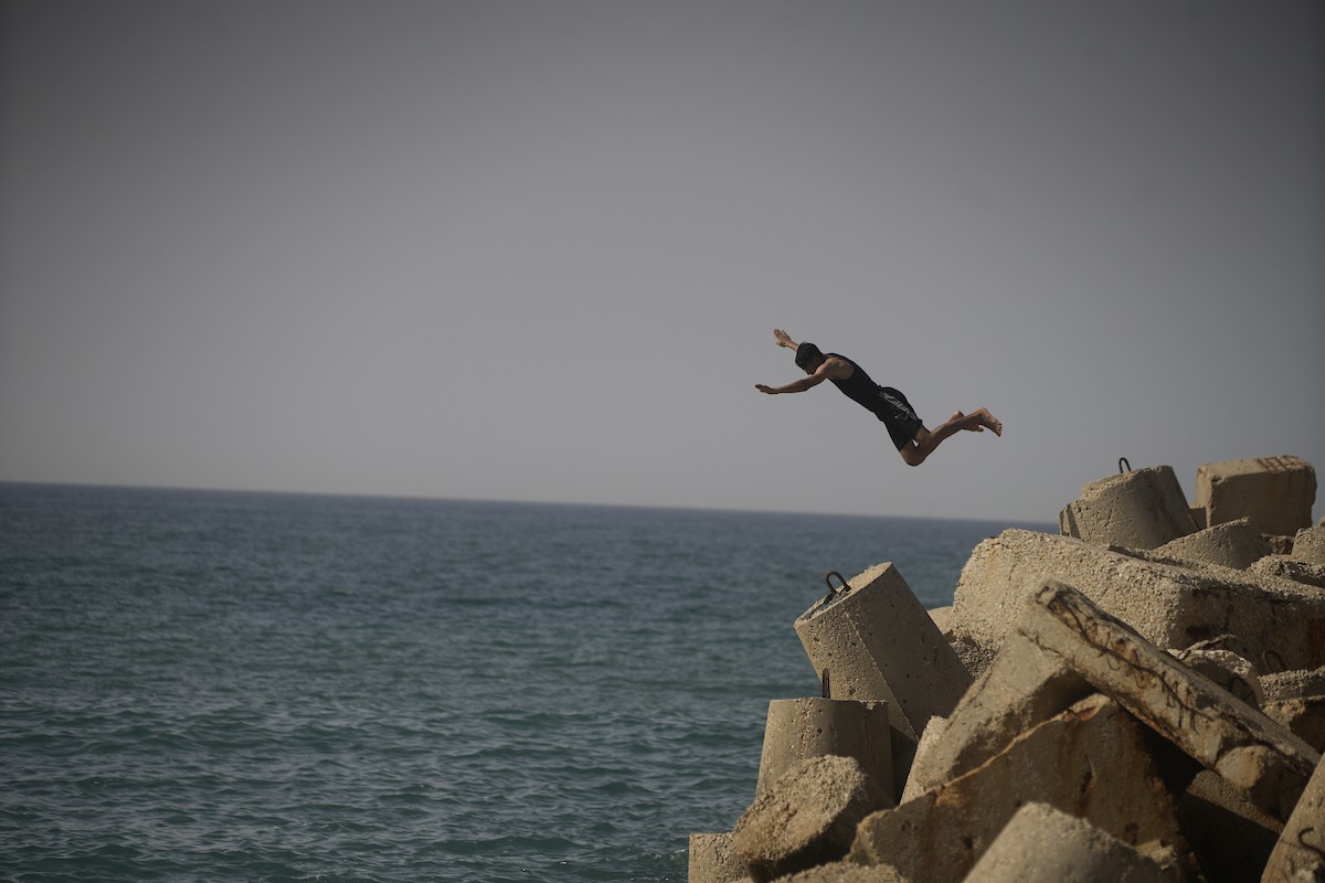 يسبح أطفال قرب ميناء غزة المدمر، في مشهد يعكس تمسكهم بلحظات الفرح رغم الدمار المحيط بهم. يُعدّ البحر في غزة المتنفس الوحيد لسكانها الذين يواجهون آثار الحرب والنزوح، والذين يعيشون في خيام تفتقر لأبسط مقومات الحياة، ١٢ فبراير ٢٠٢٦. تصوير: عمر أشتوي