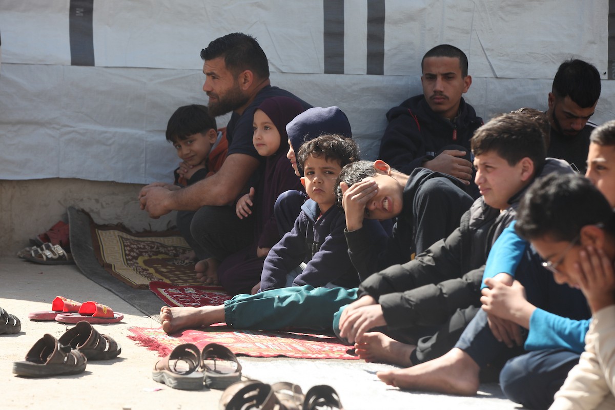 يؤدي النازحون أول صلاة جمعة في رمضان بجوار أنقاض مسجد الصفا المدمر بالكامل في مخيم البريج للاجئين وسط قطاع غزة. 20 فبراير/شباط 2026. تصوير: معز صالحي