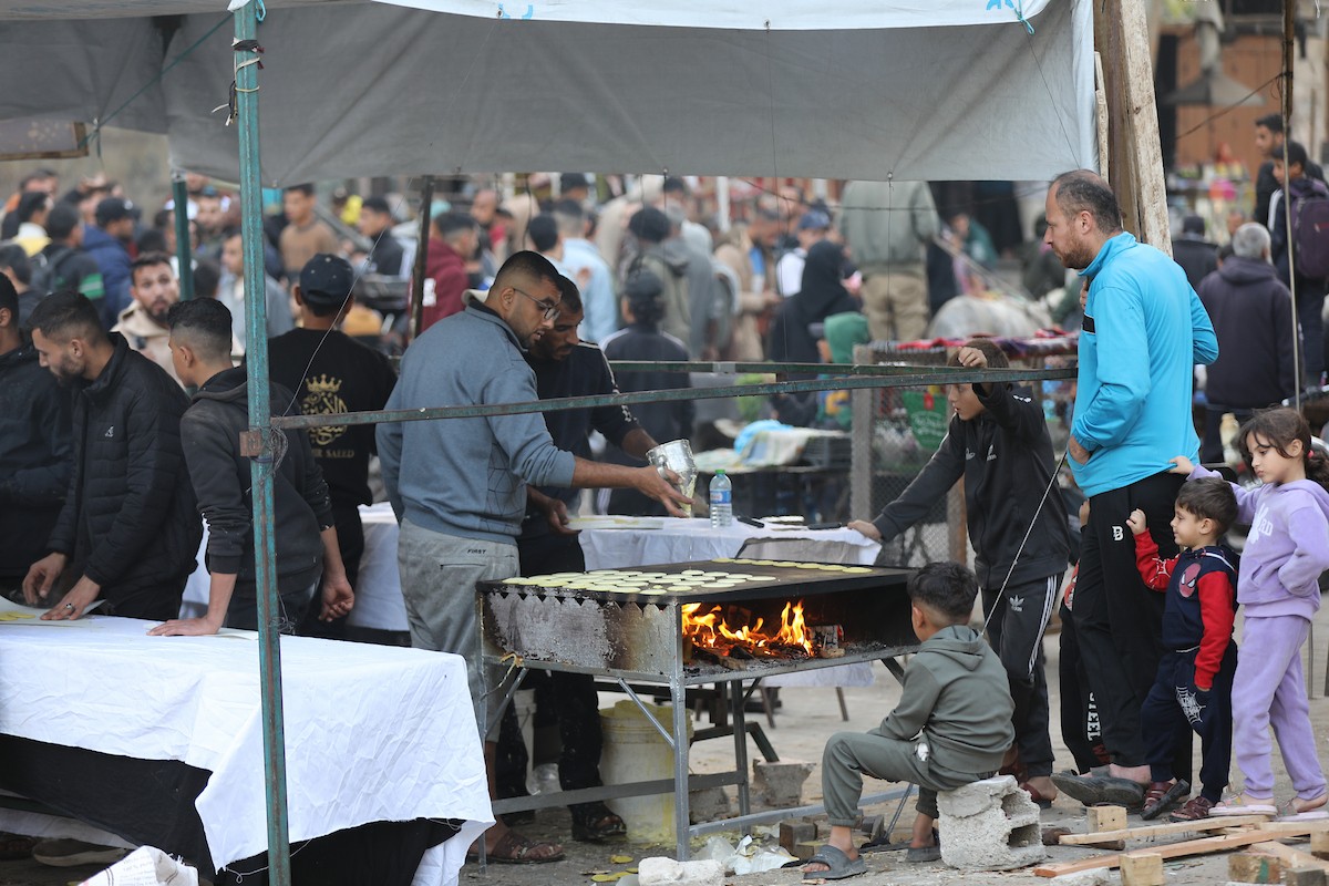 آلاء كريم نازحة في مخيم النصيرات وسط قطاع غزة، تفتح كشكًا لتحضير وبيع القطايف خلال أيام رمضان، في محاولة منها للتغلب على ظروف المعيشة القاسية وإعالة أسرتها بعد أن فقدت منزلها، 19 فبرايرشباط 2026. تصوير رمزي أبو عامر