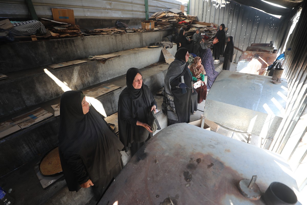 مجموعة من النساء يعملن داخل مخبز أُنشئ في مخيم اليرموك للاجئين بمدينة غزة، ضمن مبادرة إنسانية بالشراكة مع اللجنة الدولية للصليب الأحمر. تهدف المبادرة إلى تخفيف الأعباء المعيشية عن النساء النازحات، لا سيما خلال شهر رمضان. مدينة غزة، 25 فبراير/شباط 2026. تصوير: عمر أشتوي