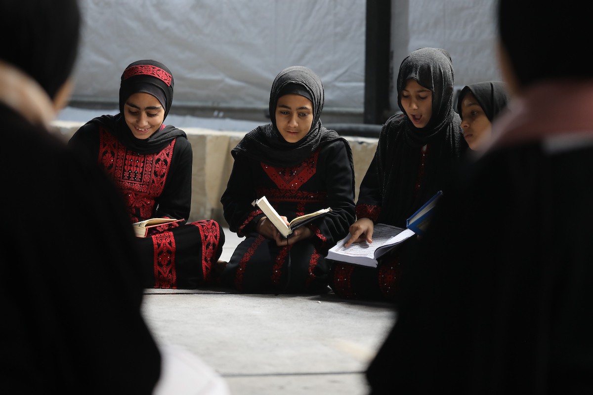 أطفال فلسطينيون يتلون ويحفظون القرآن الكريم داخل الجامع العمري الكبير في مدينة غزة خلال شهر رمضان. وقد تضرر الجامع العمري القديم بشدة جراء الهجمات الإسرائيلية خلال حرب غزة في 26 فبراير/شباط 2026. صورة: عمر أشتوي