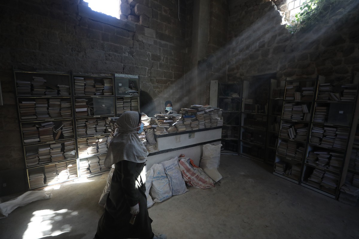 عملية الإنقاذ والترميم الأولية للكتب والمخطوطات بمكتبة الجامع العمري الكبير في البلدة القديمة بمدينة غزة في 2 مارس/آذار 2026.صورة: عمر أشتوي
