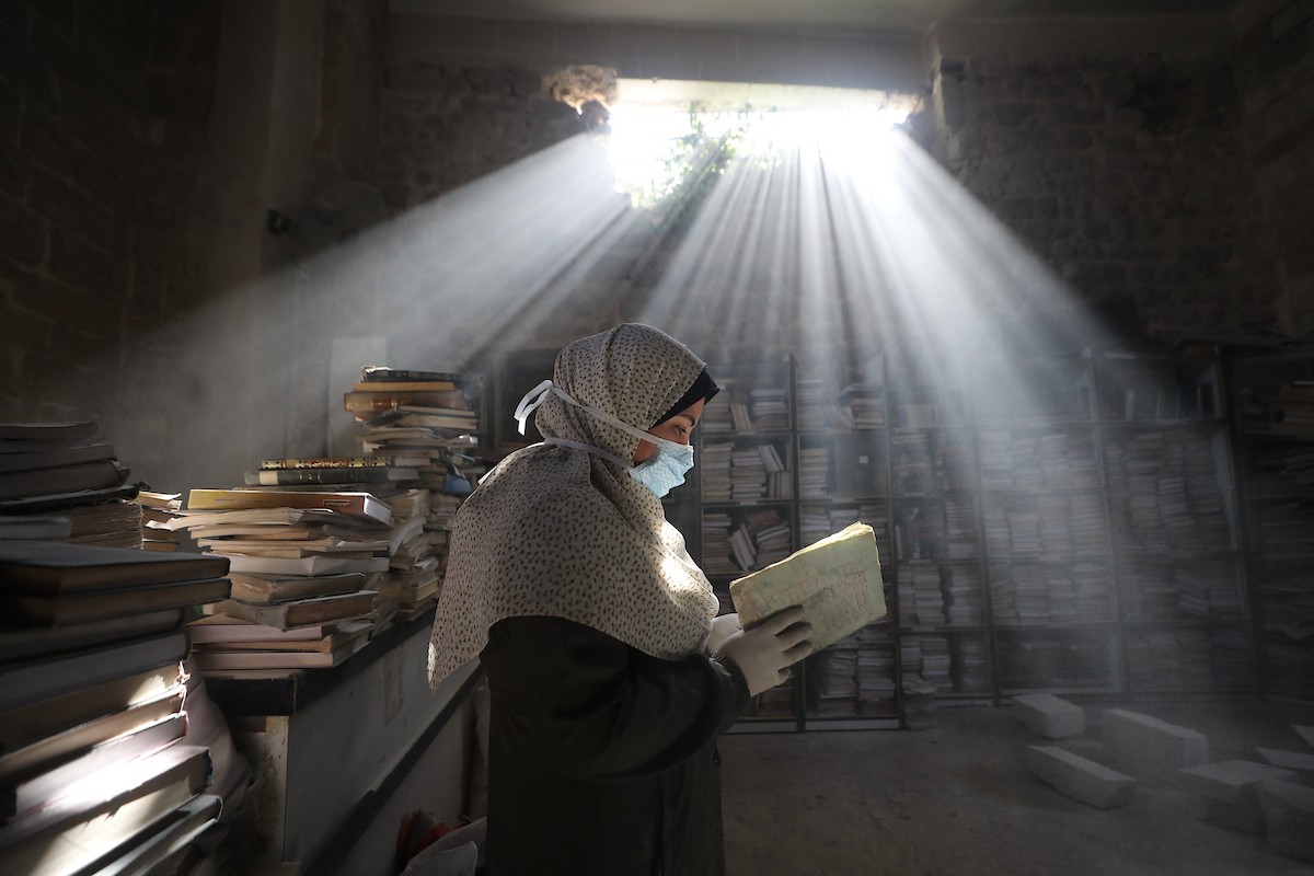 عملية الإنقاذ والترميم الأولية للكتب والمخطوطات بمكتبة الجامع العمري الكبير في البلدة القديمة بمدينة غزة في 2 مارس/آذار 2026.صورة: عمر أشتوي