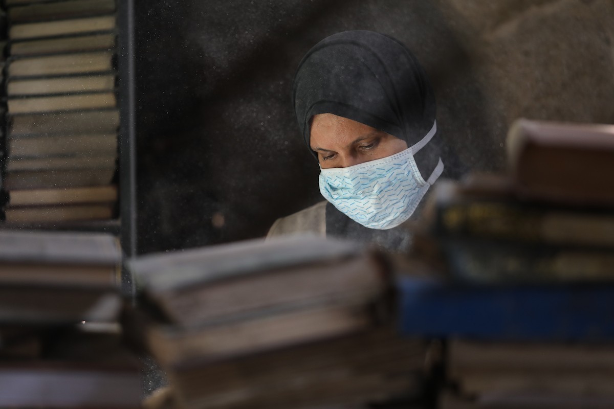عملية الإنقاذ والترميم الأولية للكتب والمخطوطات بمكتبة الجامع العمري الكبير في البلدة القديمة بمدينة غزة في 2 مارس/آذار 2026.صورة: عمر أشتوي