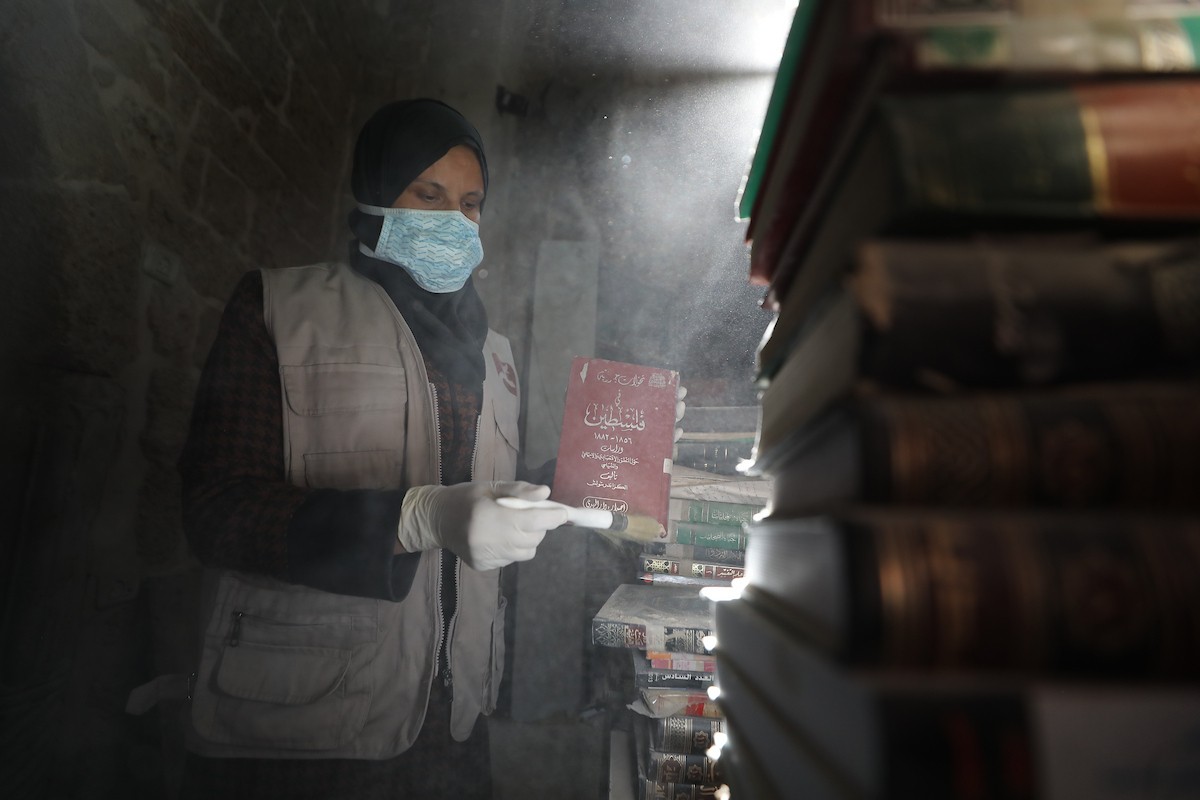 عملية الإنقاذ والترميم الأولية للكتب والمخطوطات بمكتبة الجامع العمري الكبير في البلدة القديمة بمدينة غزة في 2 مارس/آذار 2026.صورة: عمر أشتوي