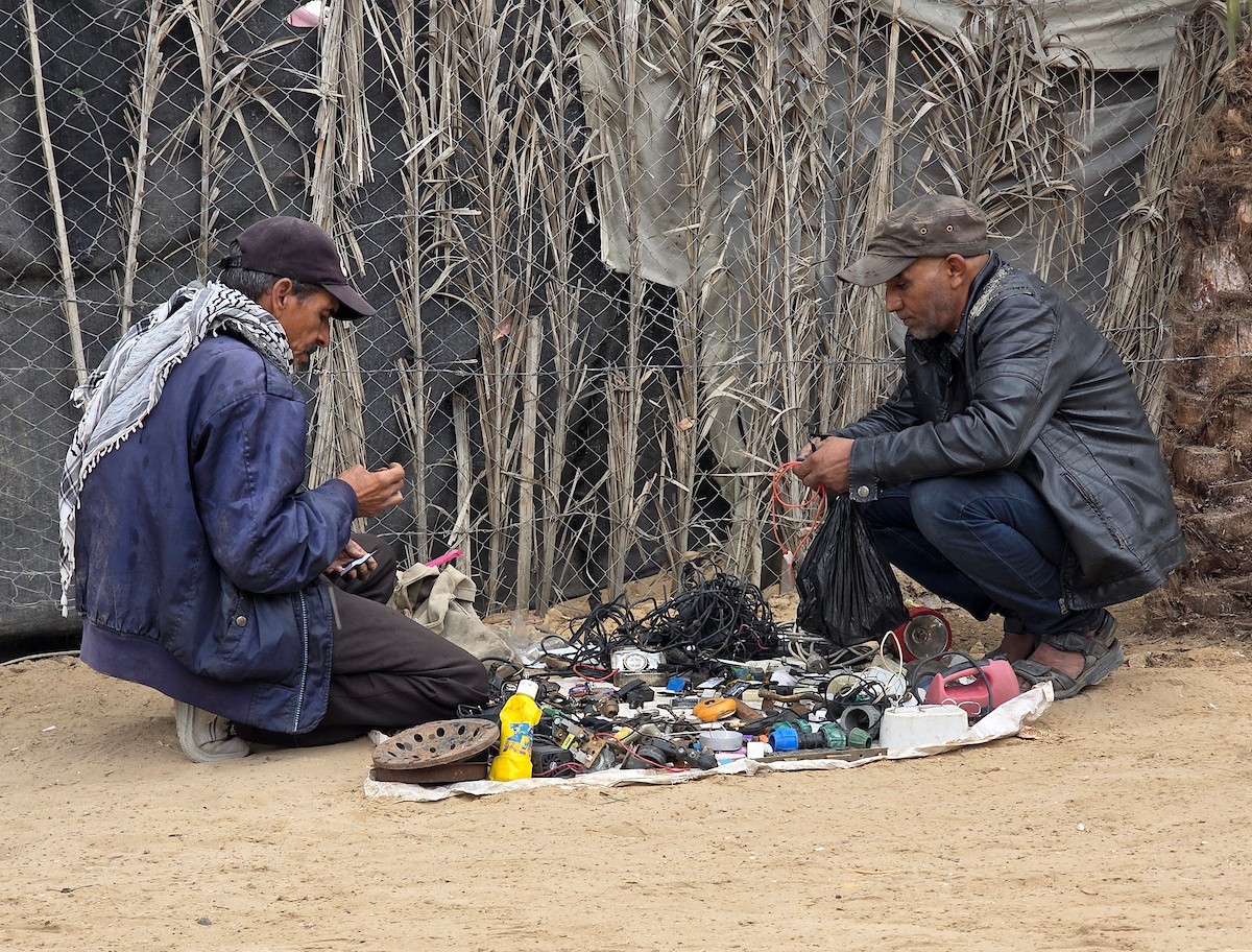 يبيع فلسطينيون موادًا مُستصلحة من أنقاض منازلهم المدمرة، بما في ذلك المعادن والخشب والأبواب ومستلزمات النظافة، في سوق للخردة بمنطقة المواصي في خان يونس جنوب قطاع غزة، في 27 أبريل/نيسان 2026 (صورة: طارق محمد)