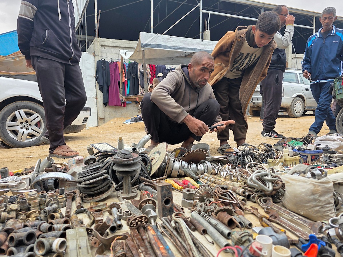 يبيع فلسطينيون موادًا مُستصلحة من أنقاض منازلهم المدمرة، بما في ذلك المعادن والخشب والأبواب ومستلزمات النظافة، في سوق للخردة بمنطقة المواصي في خان يونس جنوب قطاع غزة، في 27 أبريل/نيسان 2026 (صورة: طارق محمد)