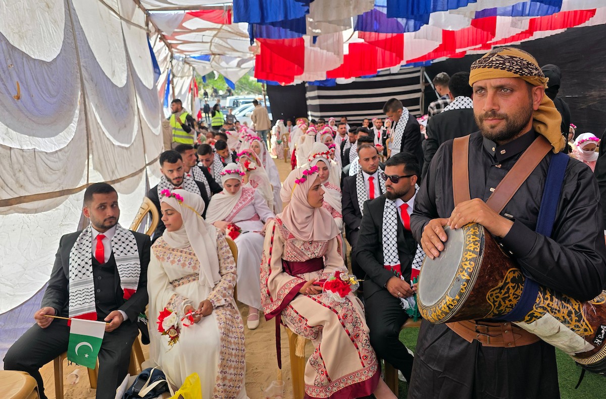 فلسطينيون يشاركون في حفل زفاف جماعي لخمسين عريساً فقدوا أفراداً من عائلاتهم خلال الحرب، ضمن مبادرة بعنوان أفراح رغم الجراح، في خان يونس، جنوب قطاع غزة. 26 أبريل/نيسان 2026، (تصوير: طارق محمد)