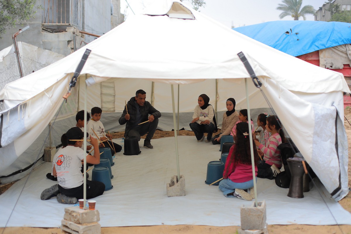 يشارك أطفال فلسطينيون في أنشطة ترفيهية ودعم نفسي اجتماعي في مخيم الزهور للنازحين في مخيم النصيرات للاجئين وسط قطاع غزة. 26 أبريل/نيسان 2026، (تصوير: حسن الجديدي)