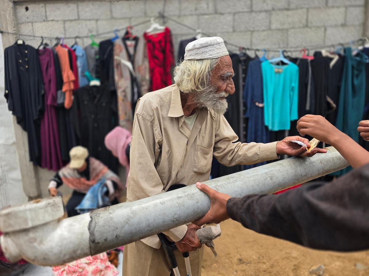يبيع فلسطينيون موادًا مُستصلحة من أنقاض منازلهم المدمرة، بما في ذلك المعادن والخشب والأبواب ومستلزمات النظافة، في سوق للخردة بمنطقة المواصي في خان يونس جنوب قطاع غزة، في 27 أبريل/نيسان 2026 (صورة: طارق محمد)