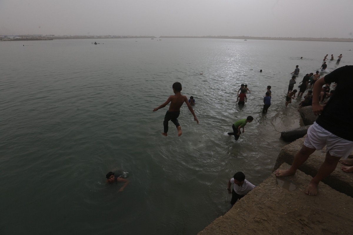 يقضي أطفال فلسطينيون أوقاتهم على شاطئ  غزة، باحثين عن ملاذ من حرارة الشمس وضغوط الحياة اليومية، في ظلّ الظروف الإنسانية المتردية التي يواجهها سكان القطاع جراء الحرب الدائرة، 17 أبريل/نيسان 2026. تصوير: بلال أسامة