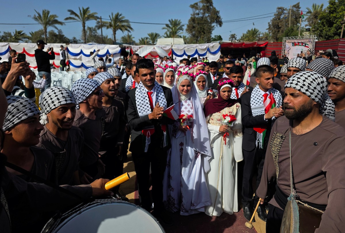 فلسطينيون يشاركون في حفل زفاف جماعي لخمسين عريساً فقدوا أفراداً من عائلاتهم خلال الحرب، ضمن مبادرة بعنوان أفراح رغم الجراح، في خان يونس، جنوب قطاع غزة. 26 أبريل/نيسان 2026، (تصوير: طارق محمد)