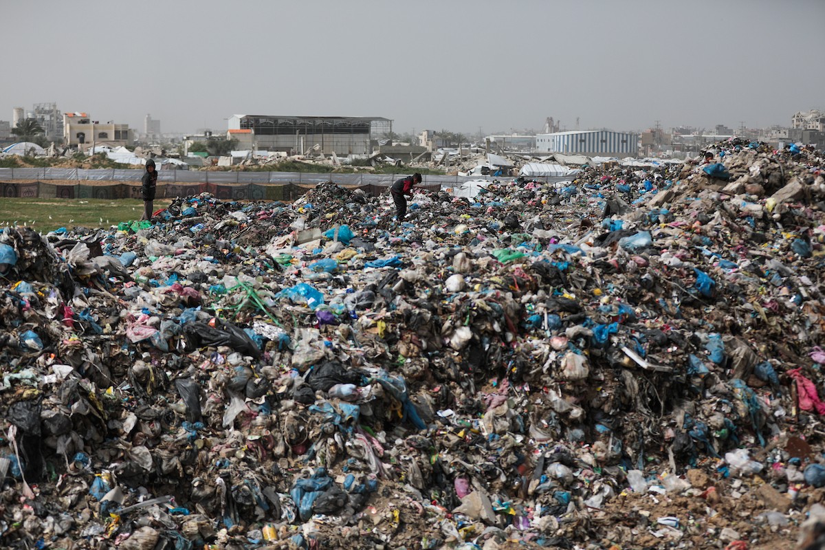أطفال فلسطينيون يبحثون بين أكوام القمامة عن بقايا الطعام أو الألعاب في مكب نفايات بمخيم البريج للاجئين وسط قطاع غزة، في 4 أبريل/نيسان 2026، بالتزامن مع يوم الطفل الفلسطيني.(صورة: رمزي أبو عامر)