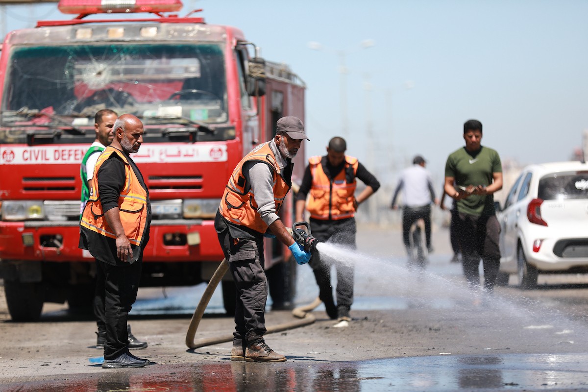 فلسطينيون يتفقدون سيارة مدنية مدمرة بعد استهدافها في غارة جوية إسرائيلية أسفرت عن مقتل ثلاثة أشخاص في شارع صلاح الدين، جنوب مخيم البريج للاجئين وسط قطاع غزة، 23 أبريل/نيسان 2026. صورة: رمزي أبو عامر