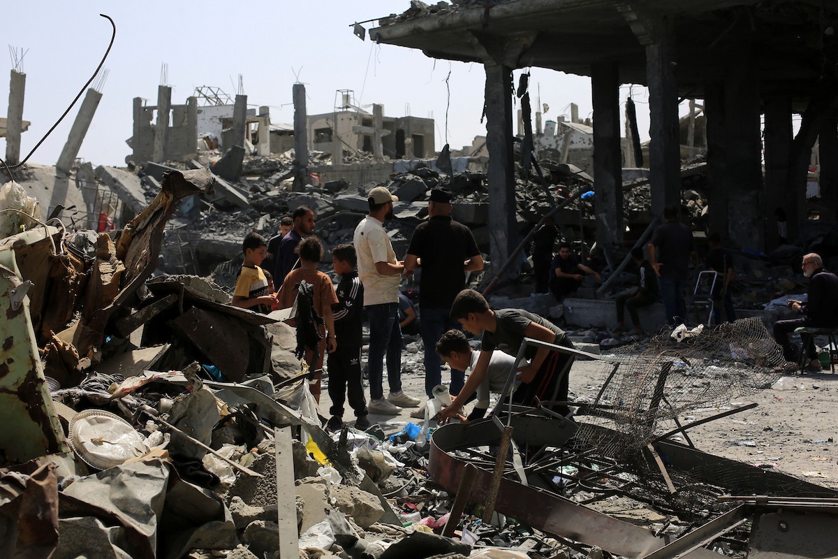 فلسطينيون يتفقدون منازلهم المدمرة عقب غارة جوية إسرائيلية ليلية استهدفت مبنى سكنياً بعد تحذير السكان بإخلائه، في جباليا شمال قطاع غزة، يوم 19 مايو/أيار 2026. تصوير: بلال أسامة