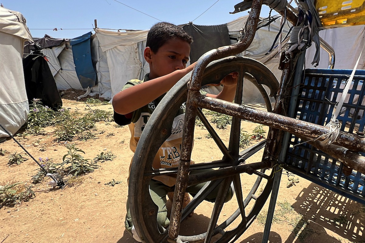 الطفل الفلسطيني مالك أبو نصر، 10 سنوات، يعمل بعربة نقل في دير البلح وسط قطاع غزة لإعالة والدته المريضة وإخوته الصغار، بعدما فقد والده في غارة إسرائيلية خلال الحرب، في 20 أيار/ مايو 2026. تصوير: يوسف أبو وطفة.