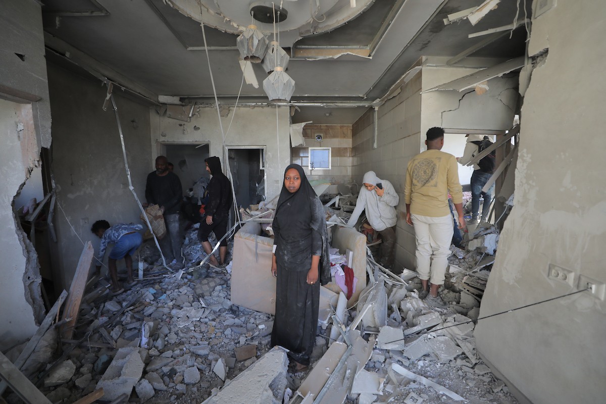 فلسطينيون يتفقدون منازلهم المدمرة عقب غارة جوية إسرائيلية ليلية على مخيم المغازي للاجئين وسط قطاع غزة، في 21 مايو/أيار 2026. الصورة: حسن الجديدي.