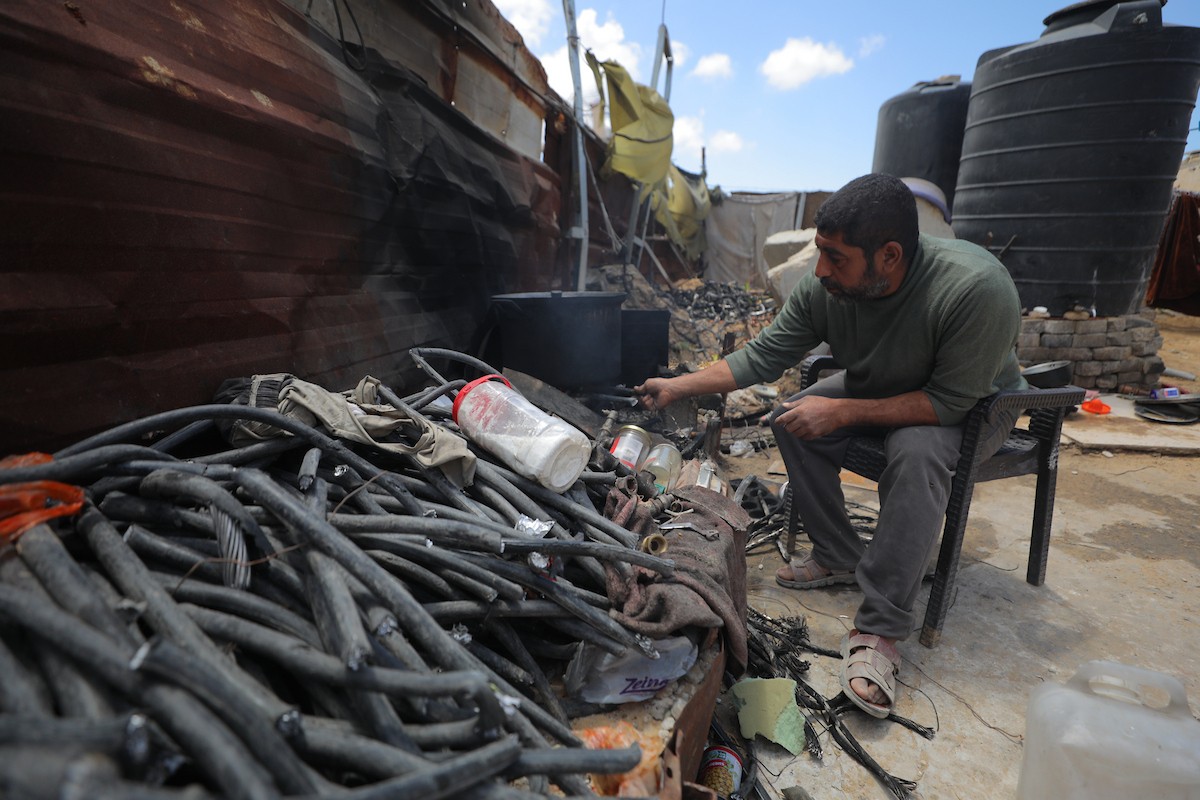يقضي فلسطينيون نازحون يومهم داخل خيام مهترئة نُصبت بين أنقاض المباني المدمرة في دير البلح وسط قطاع غزة، يوم الإثنين 11 مايو/أيار 2026، في ظل أوضاع إنسانية قاسية وانهيار واسع في مقومات الحياة الأساسية.  (صورة: حسن الجديدي)