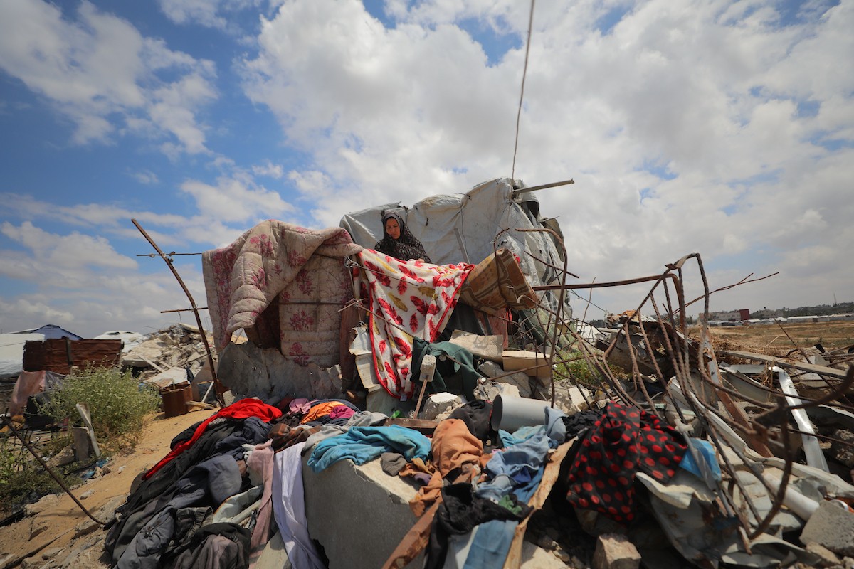 يقضي فلسطينيون نازحون يومهم داخل خيام مهترئة نُصبت بين أنقاض المباني المدمرة في دير البلح وسط قطاع غزة، يوم الإثنين 11 مايو/أيار 2026، في ظل أوضاع إنسانية قاسية وانهيار واسع في مقومات الحياة الأساسية.  (صورة: حسن الجديدي)