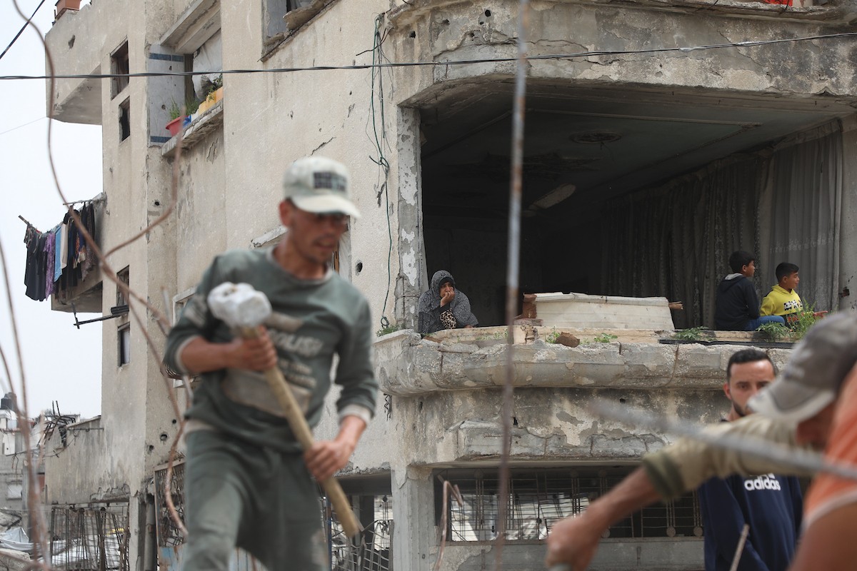 أفراد من عائلة خلة الفلسطينية ينتشلون رفات ضحيتين من تحت أنقاض منزلهم المدمر في منطقة جباليا النزلة شمال قطاع غزة، في 12 مايو/أيار 2026، بعد أكثر من عامين ونصف من استهداف المنزل خلال العمليات العسكرية الإسرائيلية. ولا تزال رفات أكثر من 25 شخصاً يُعتقد أنها عالقة تحت الركام. تصوير: عمر أشتوي