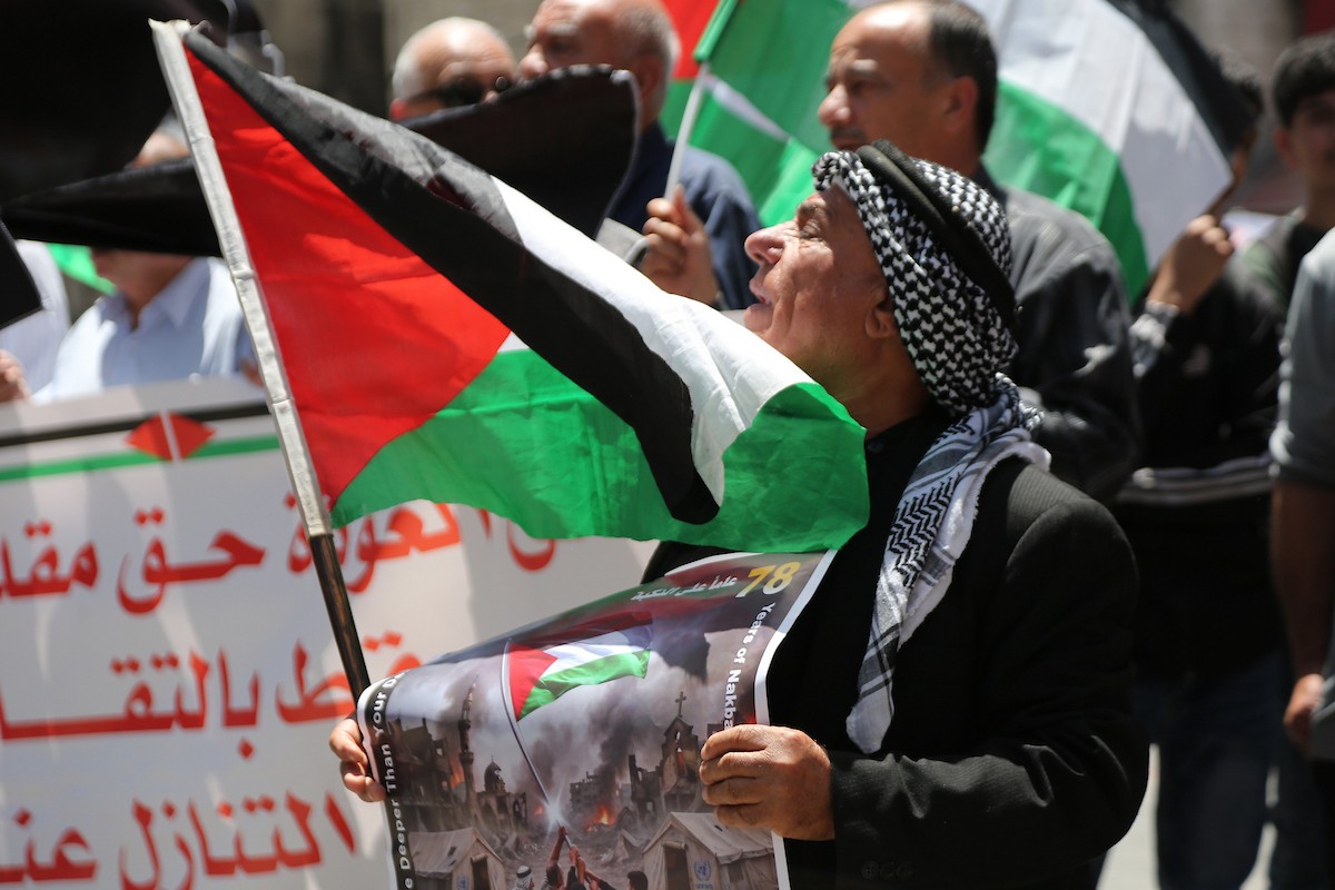 تجمع فلسطينيون في مدينة نابلس بالضفة الغربية، 11 مايو/أيار 2026، حاملين الأعلام الوطنية، خلال فعالية لإحياء  الذكرى الثامنة والسبعين للنكبة الفلسطينية، التي يستذكر فيها الفلسطينيون تهجير مئات الآلاف من ديارهم عام 1948 عقب قيام دولة إسرائيل.(صورة: محمد ناصر)