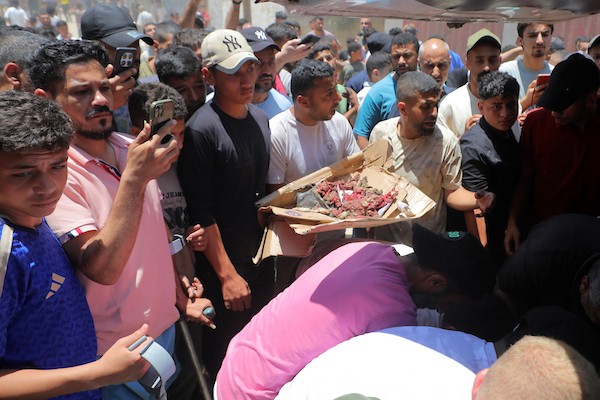 يتجمع فلسطينيون حول جثماني الشهيدين أحمد ومحمود وليد أبو هين، اللذين ارتقيا في غارة إسرائيلية استهدفت مخيم النصيرات. تصوير: حسن الجديدي