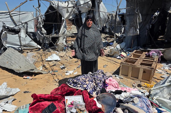 نازحون فلسطينيون يتفقدون الأضرار التي لحقت بخيامهم في منطقة مواصي خان يونس، جنوب قطاع غزة، عقب غارة إسرائيلية استهدفت المنطقة. تصوير: طارق محمد