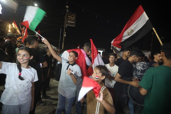 فلسطينيون يتابعون عبر شاشة عرض عامة في مدينة غزة مباراة مصر وأستراليا ضمن دور الـ32 من كأس العالم، في 3 يوليو/تموز 2026، وسط التحديات الإنسانية المستمرة في القطاع.  صورة: بلال أسامة