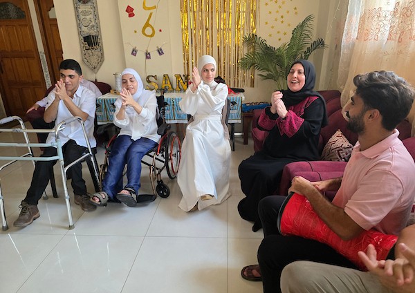 التوائم الفلسطينيون عبد الله وندى وسما موسى يحتفلون بنتائجهم المتميزة في امتحانات التوجيهي بمدينة خان يونس، جنوب قطاع غزة، بعد تجاوزهم ظروف الحرب والنزوح والإعاقة، 24 تموز/ يوليو 2026. تصوير: طارق محمد
