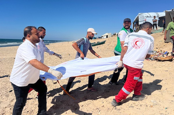 انتشل مسعفون جثة فلسطيني وأجلوا جرحى من موقع غارة إسرائيلية استهدفت مركبة مدنية غرب مخيم النصيرات للاجئين وسط قطاع غزة، في 11 يوليو/تموز 2026. صورة: حسن الجدي