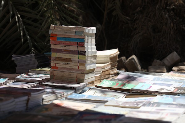 يعرض بائع الكتب محمد رمضان سعد ( 56 عامًا) مجموعة من الكتب في كشك على جانب الطريق في دير البلح، وسط قطاع غزة، في 2 يوليو/تموز 2026. تصوير: حسن الجدي