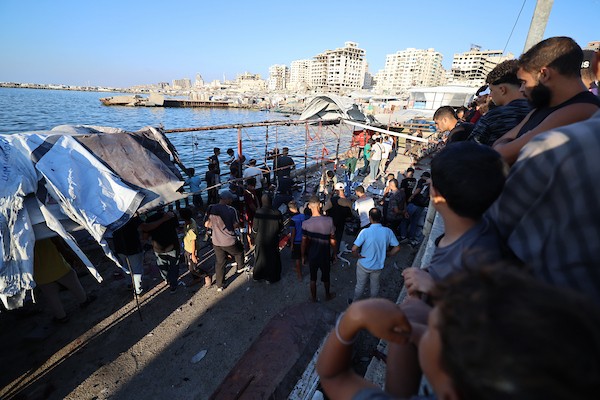 فلسطينيون في موقع غارة جوية إسرائيلية استهدفت مجموعة من المدنيين على الواجهة البحرية غرب مدينة غزة، في 18 أغسطس/آب 2026.(صورة: هادي داود)