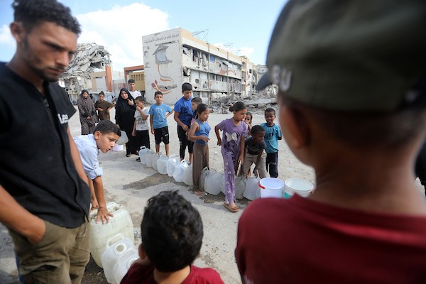 نازحون فلسطينيون ينتظرون الحصول على المياه قرب