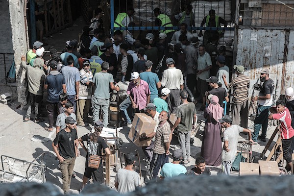 فلسطينيون يتلقون مساعدات غذائية من برنامج الأغذية العالمي في مخيم النصيرات وسط قطاع غزة، في 19 أغسطس/آب 2026، بالتزامن مع اليوم العالمي للعمل الإنساني. الصورة: معز صالحي