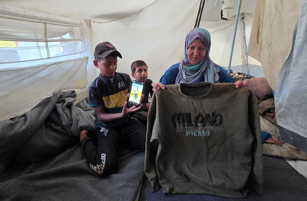 الفلسطينية سمية الرقب تحتضن صورة وملابس ابنها أحمد داخل خيمة للنازحين في خان يونس، جنوب قطاع غزة، في 30 أغسطس/آب 2026، بينما تواصل انتظار أي خبر عن مصيره في اليوم الدولي للمفقودين.